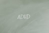 Simple illustration highlighting ADHD awareness with text on a gray background.